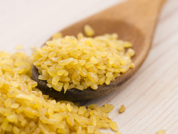 bulgur wheat in wooden spoon