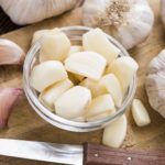 Rustic style Garlic (peeled) on vintage wooden background