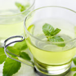 closeup of fresh mint tea, surrounded by fresh mint