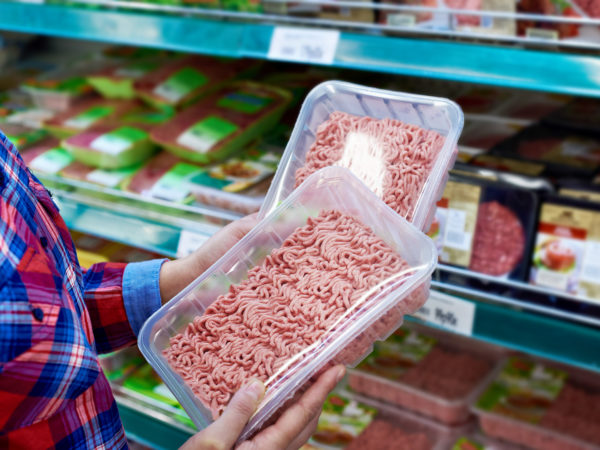 Buyer chooses minced meat in a store