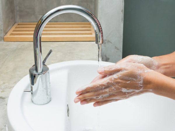 hands being washed with soap.