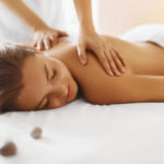 Spa woman. Female enjoying relaxing back massage in cosmetology spa centre. Body care, skin care, wellness, wellbeing, beauty treatment concept.