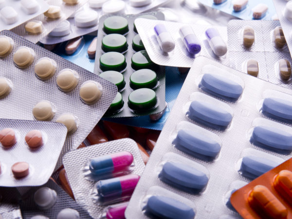 Close up of packs of pills and capsules.