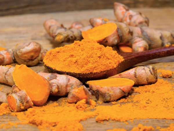 Sjögren&#039;s Syndrome fresh turmeric roots on wooden table