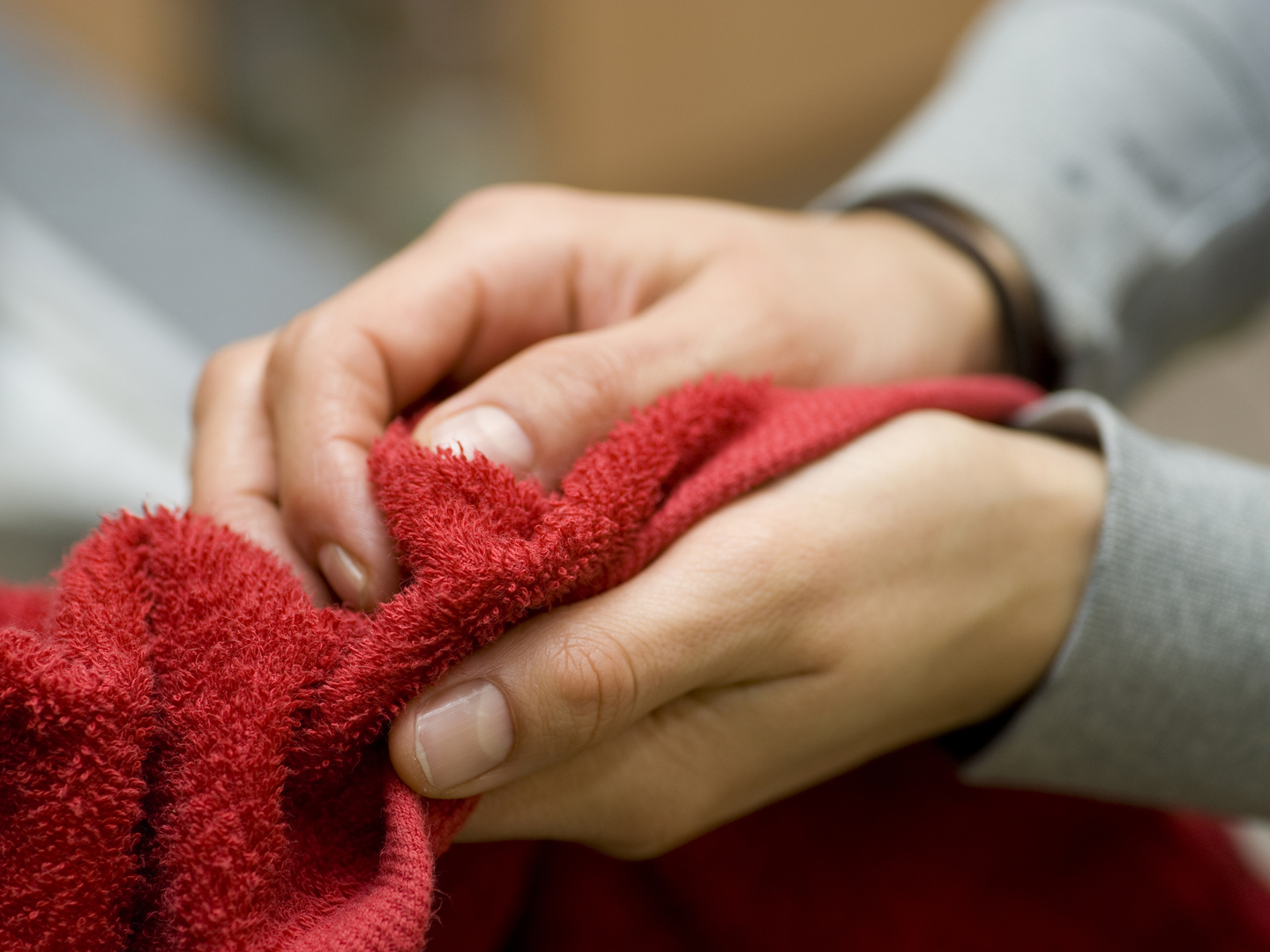 drying hands with red towel