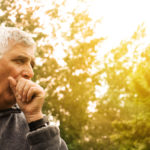 Coughing Senior Man on fresh air.