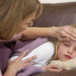 Mother Taking Temperature Of Sick Daughter at home