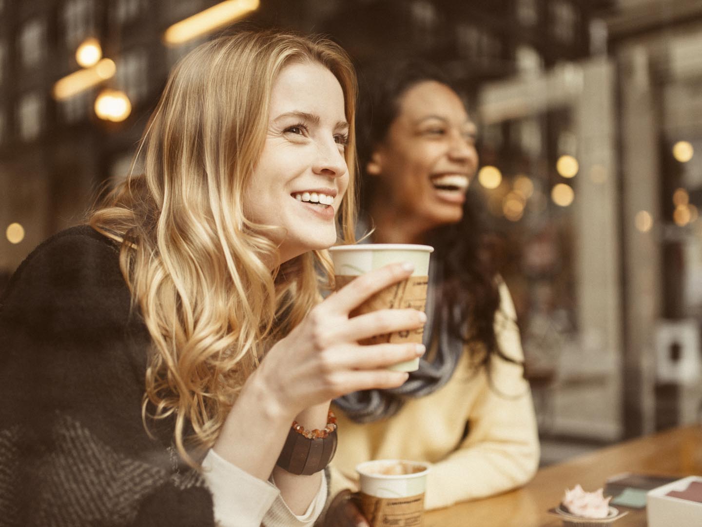 Girlfriends sharing a laugh in Coffeeshop