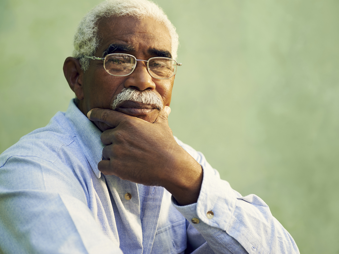 Black people and emotions, portrait of depressed senior man with glasses looking at camera. Copy space