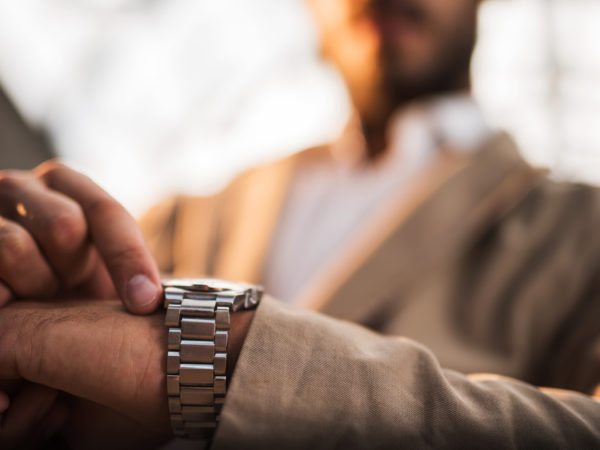 Close up of unrecognizable businessman checking the time on his watch.