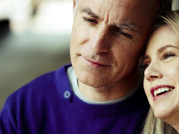 Mature couple enjoying each other, smiling and thinking.