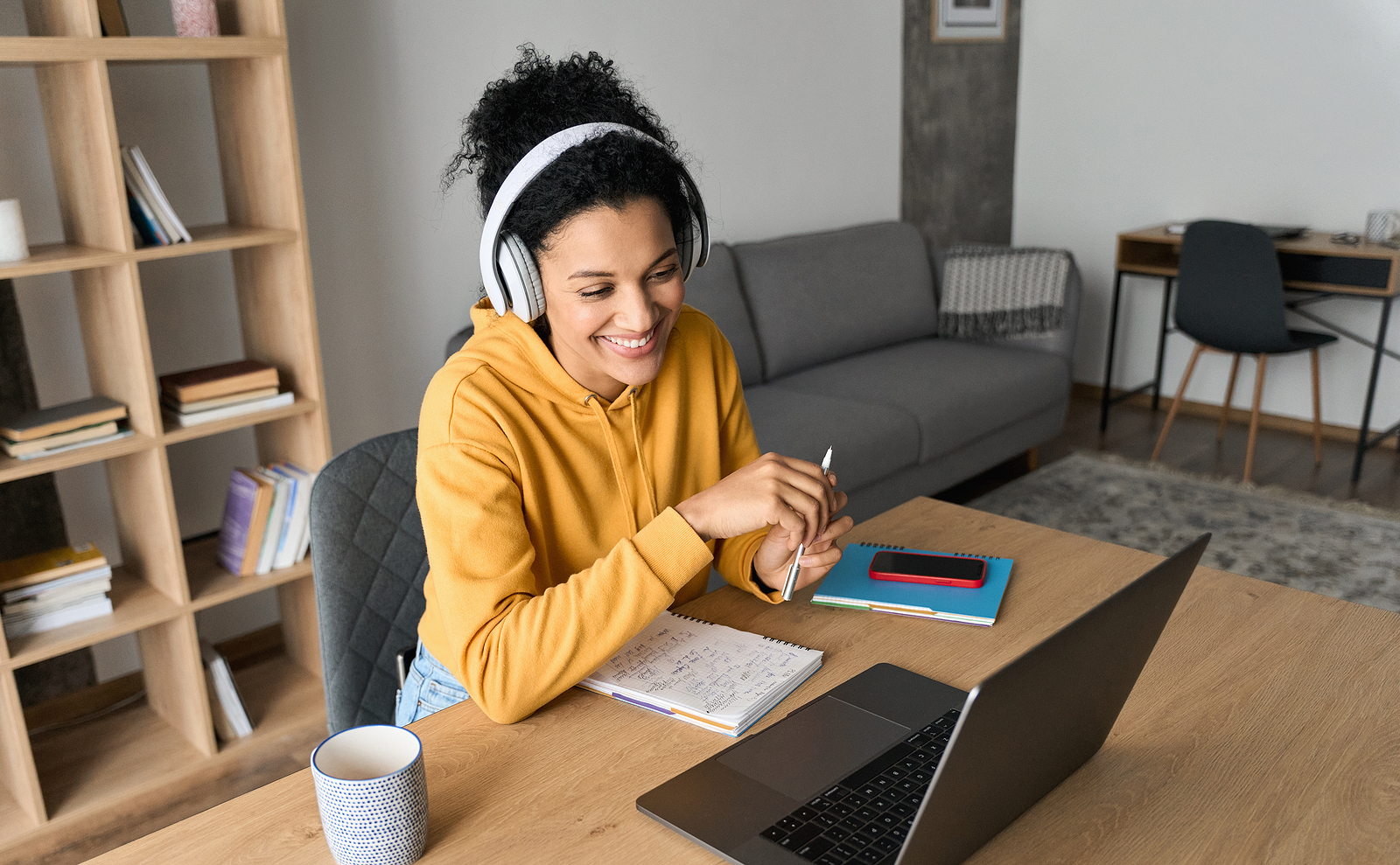 Woman smiling and working on laptop