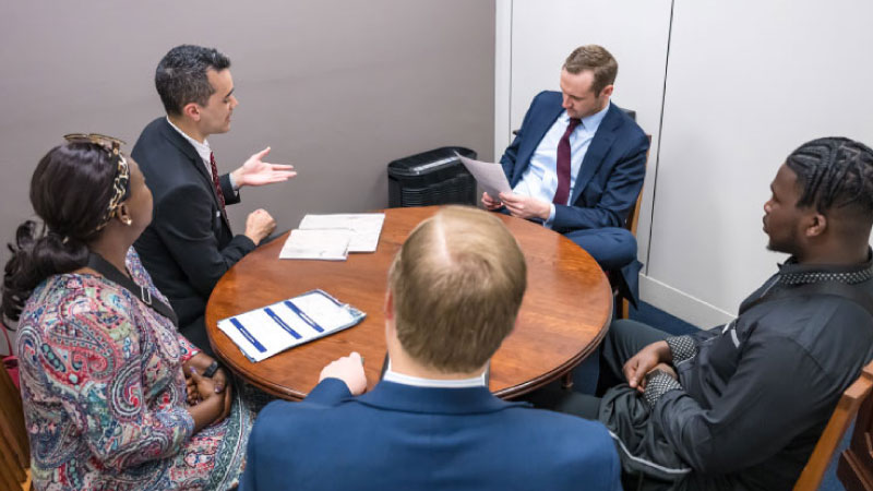 Workers discussing around a table