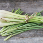 Fresh lemongrass (citronella) on wooden background - Spice for health.