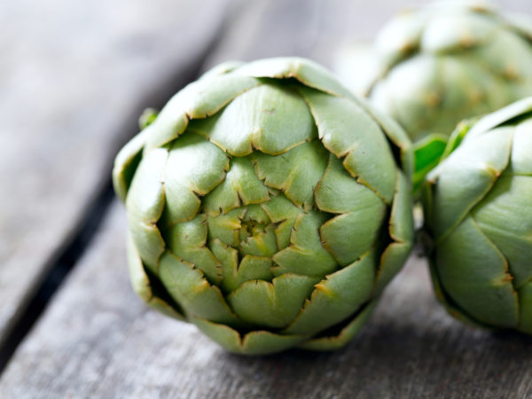 artichokes on wooden surface